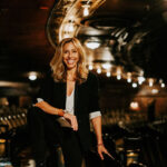 Amanda Green, the lyricist who updated 'Kiss Me, Kate,' poses in a reflective moment, showcasing her thoughtful approach to modernizing classic musical theatre while preserving its core essence.