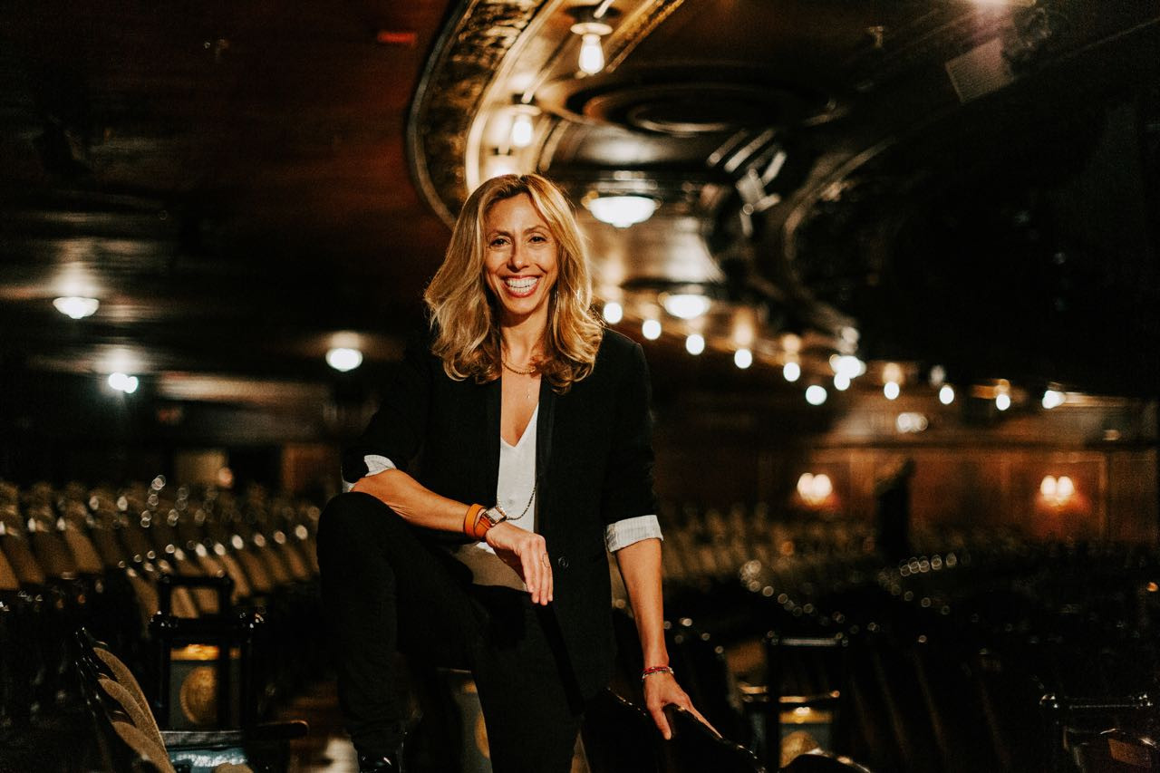 Amanda Green, the lyricist who updated 'Kiss Me, Kate,' poses in a reflective moment, showcasing her thoughtful approach to modernizing classic musical theatre while preserving its core essence.