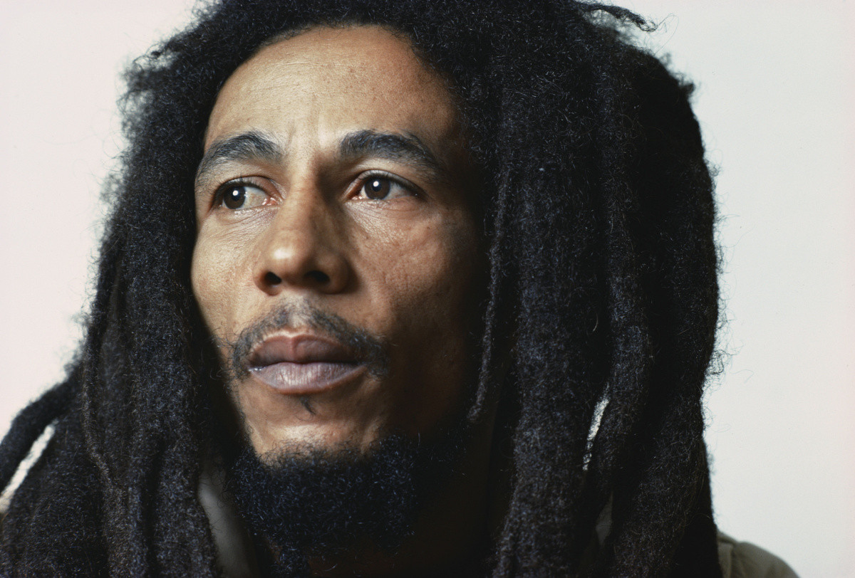 Bob Marley performing, capturing the essence of the artist behind the iconic 'Three Little Birds' song and its message of peace and optimism.