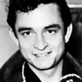 Johnny Cash in a classic pose, highlighting his iconic look and guitar