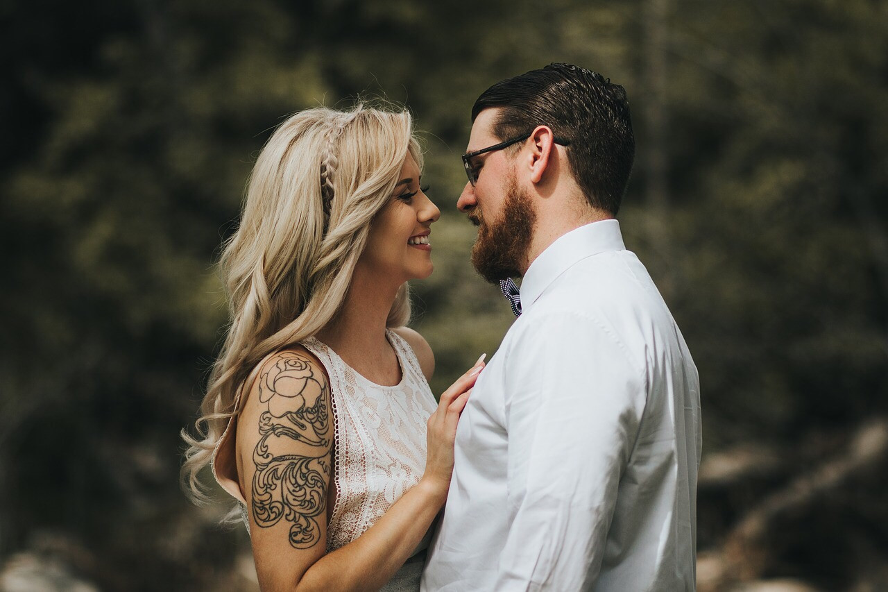 A person's shoulder with a tattoo visible